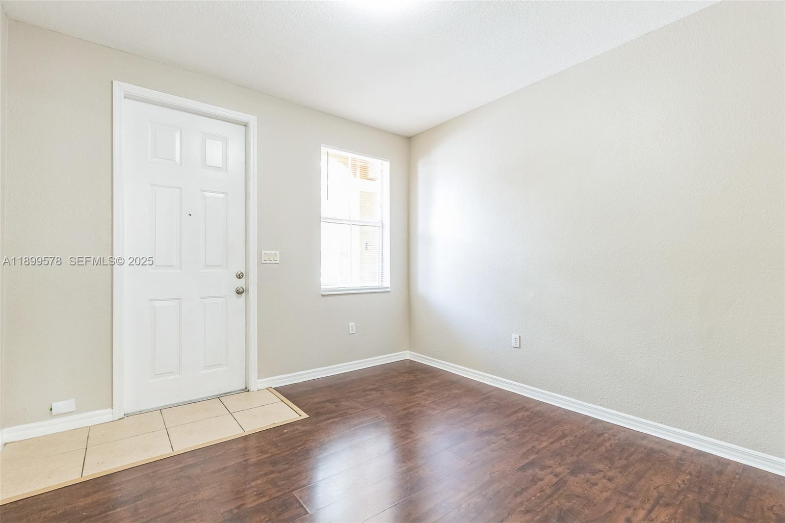 24066 Southwest 109th Court Homestead, FL 33032 - Photo 30 of 37 an empty room with wooden floor and windows