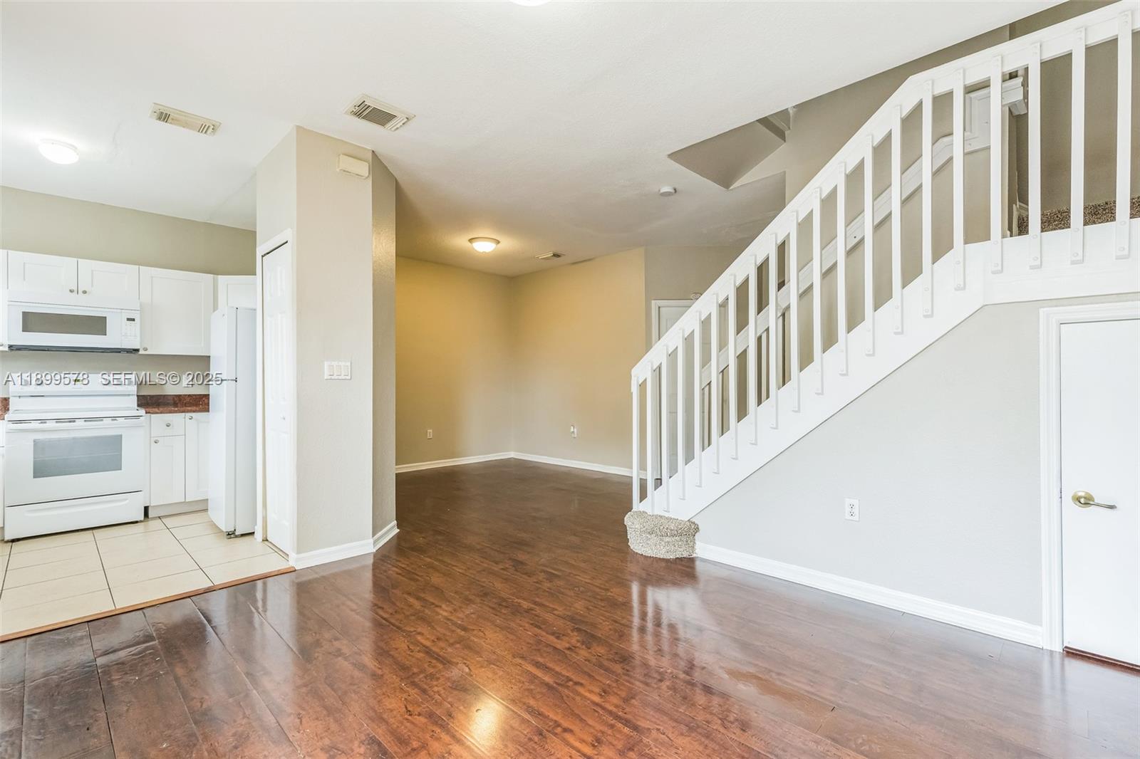 24066 Southwest 109th Court Homestead, FL 33032 - Photo 3 of 37 a view of front door and hallway with wooden floor
