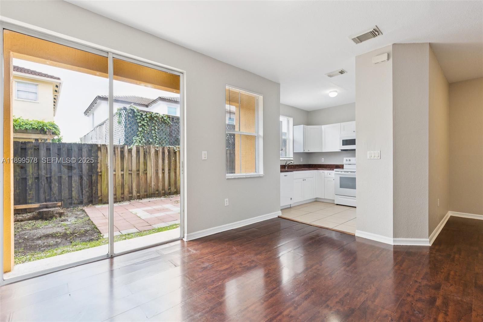 24066 Southwest 109th Court Homestead, FL 33032 - Photo 6 of 37 a view of a kitchen with wooden floor and a kitchen