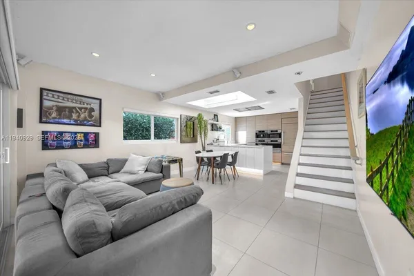 a living room with furniture and a large window