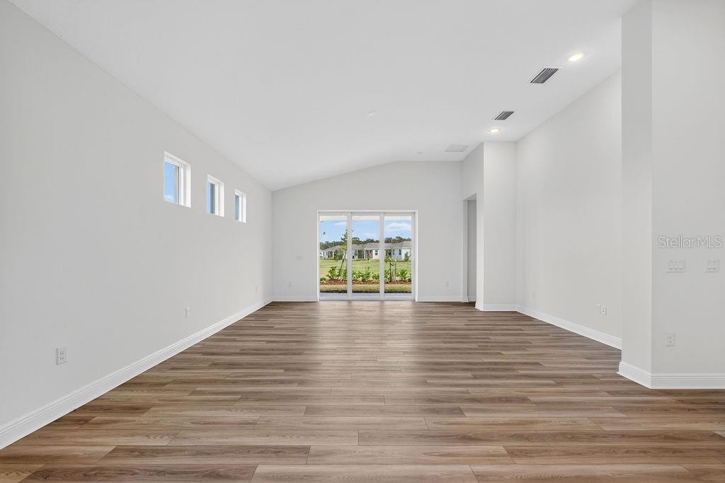 3951 Kennebunk Loop Mount Dora, FL 32757 - Photo 14 of 51 a view of empty room with wooden floor and fan