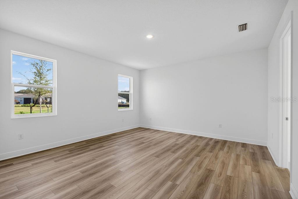 3951 Kennebunk Loop Mount Dora, FL 32757 - Photo 16 of 51 an empty room with wooden floor and windows