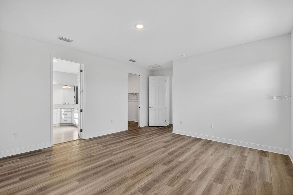 3951 Kennebunk Loop Mount Dora, FL 32757 - Photo 17 of 51 a view of an empty room with wooden floor and a window