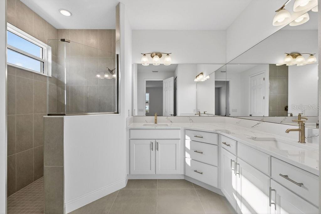 3951 Kennebunk Loop Mount Dora, FL 32757 - Photo 18 of 51 a spacious bathroom with a double vanity sink and mirror