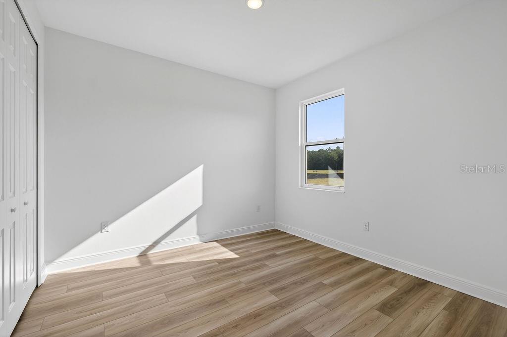 3951 Kennebunk Loop Mount Dora, FL 32757 - Photo 23 of 51 a view of a room with wooden floor and white walls