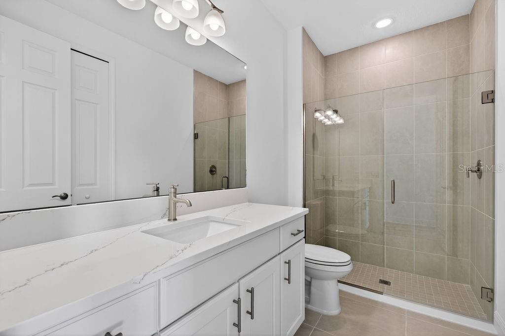 3951 Kennebunk Loop Mount Dora, FL 32757 - Photo 27 of 51 a bathroom with a sink a toilet and shower