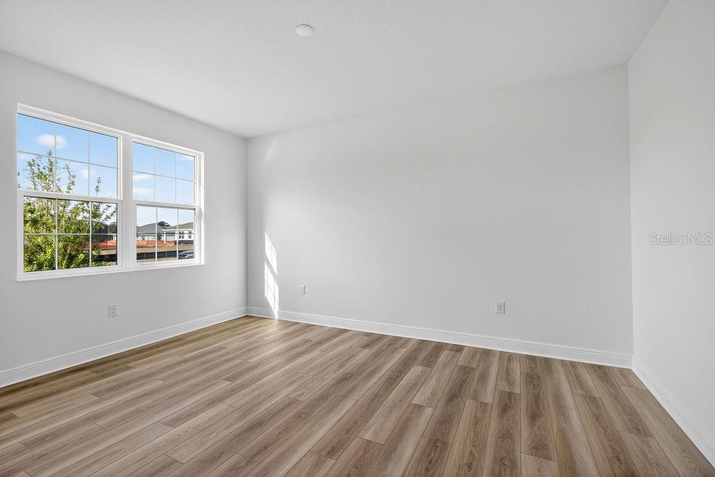 3951 Kennebunk Loop Mount Dora, FL 32757 - Photo 28 of 51 a view of an empty room with wooden floor and a window