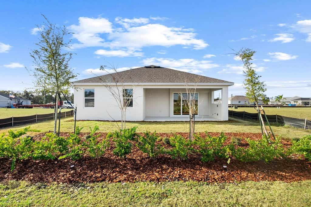 3951 Kennebunk Loop Mount Dora, FL 32757 - Photo 34 of 51 a front view of a house with a garden