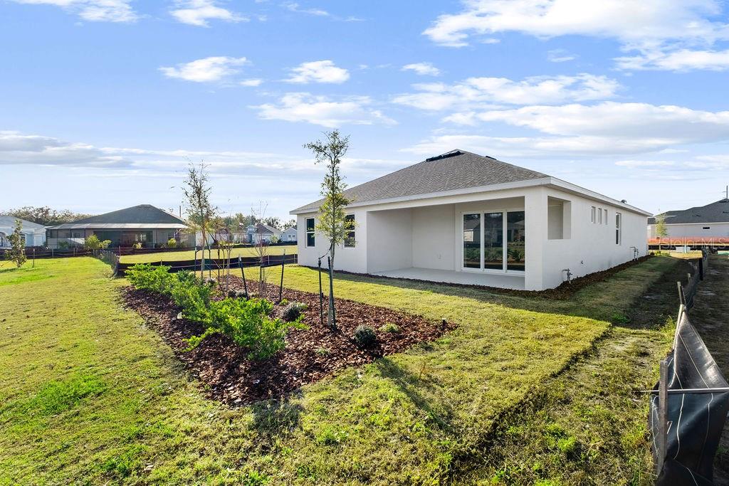 3951 Kennebunk Loop Mount Dora, FL 32757 - Photo 36 of 51 a view of a house with a yard
