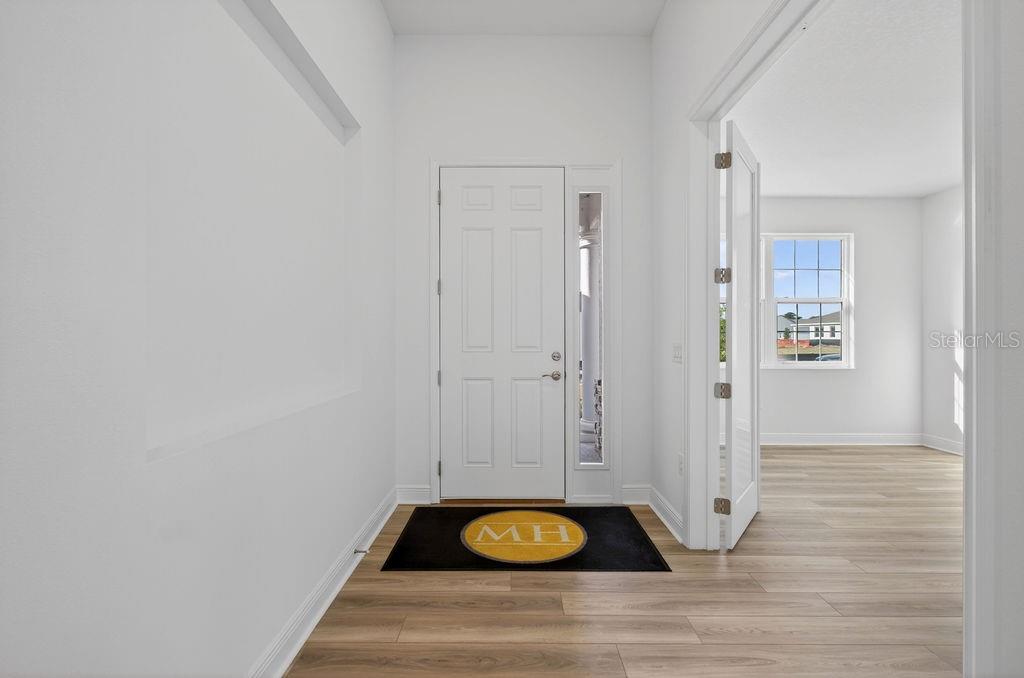 3951 Kennebunk Loop Mount Dora, FL 32757 - Photo 6 of 51 a view of an entryway with wooden floor