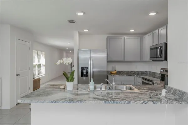 a kitchen with a refrigerator and microwave