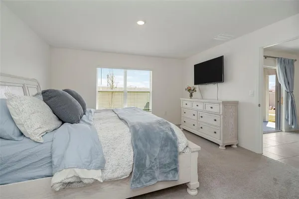 a bedroom with a bed and flat screen tv