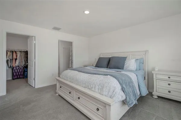a bedroom with a bed and a night stand