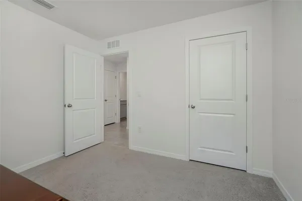 an empty room with closet area