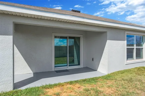 a view of backyard with large windows