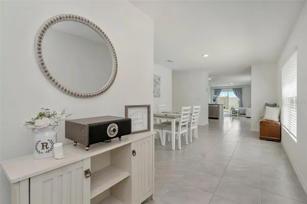 a living room with furniture and a mirror