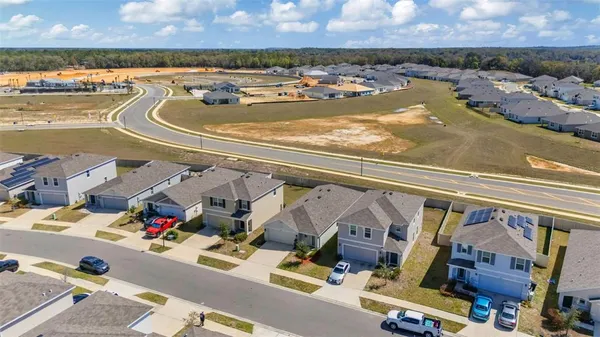 an aerial view of residential houses with outdoor space