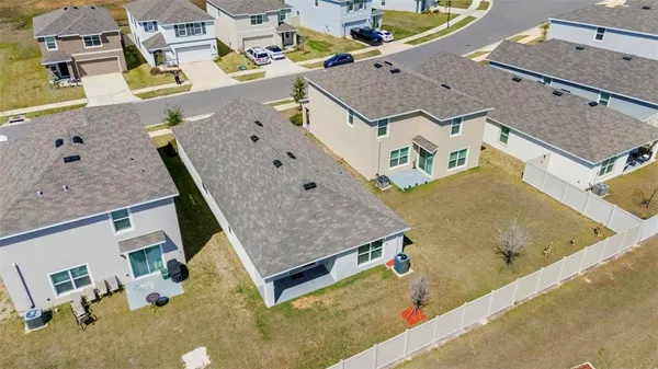 an aerial view of residential houses with outdoor space