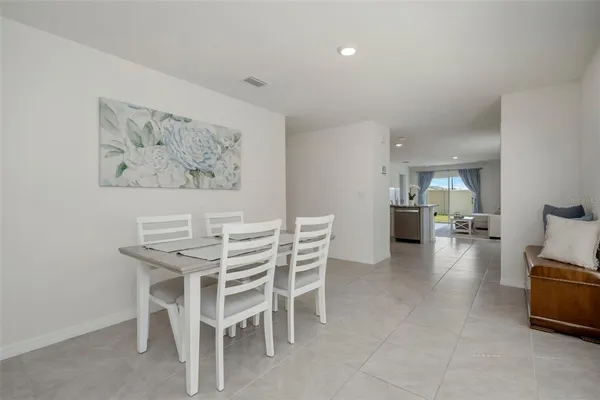 a dining room with furniture and a view of kitchen