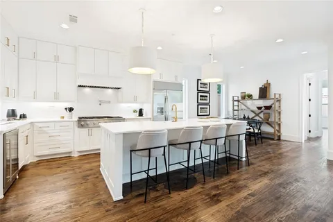 a kitchen with kitchen island hardwood floor and a sink