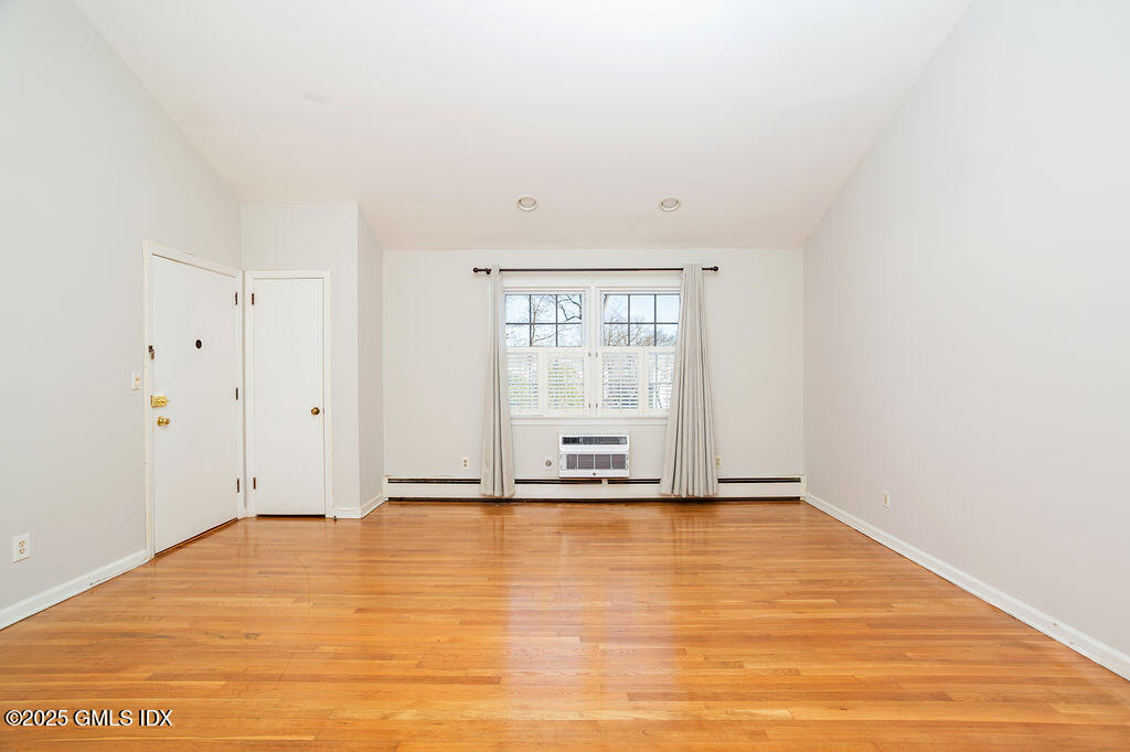 47 Valley Road, Unit B3 Cos Cob, CT 06807 - Photo 3 of 17 a view of an empty room with wooden floor and a window