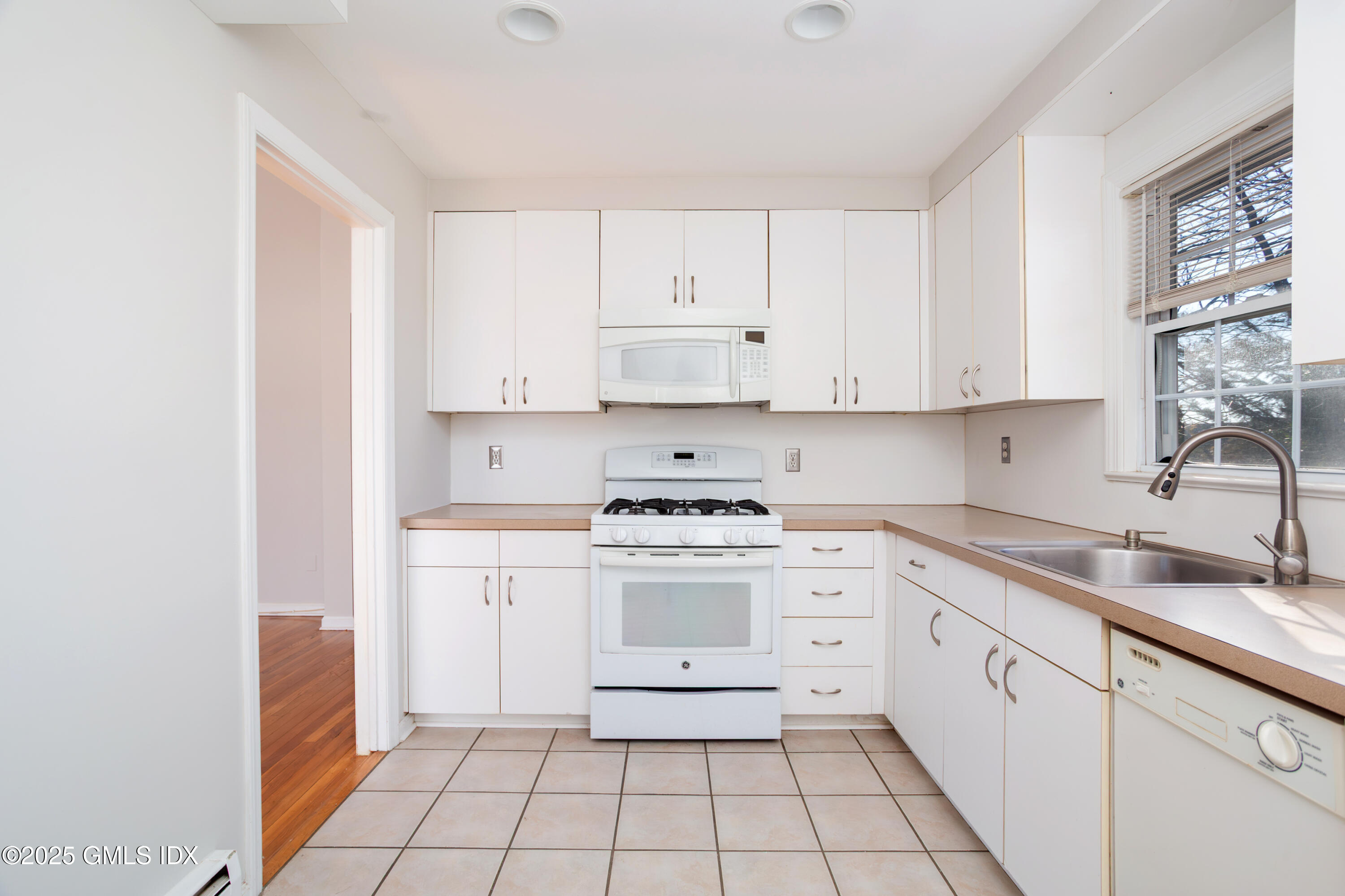 47 Valley Road, Unit B3 Cos Cob, CT 06807 - Photo 8 of 17 a kitchen with a stove sink and cabinets
