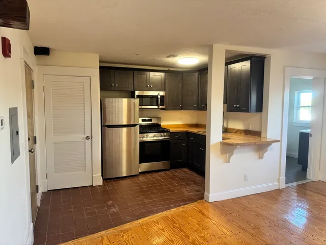 a kitchen with a refrigerator and a sink