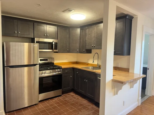 a kitchen with a refrigerator sink and stove