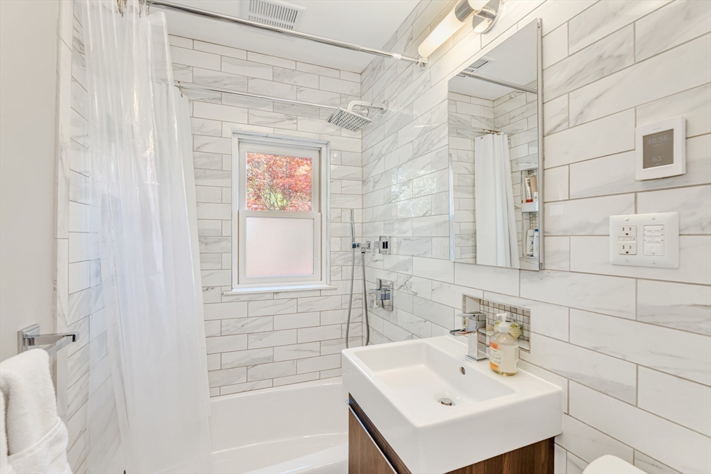 112 Perham Street Boston, MA 02132 - Photo 23 of 36 a bathroom with a sink a toilet and shower