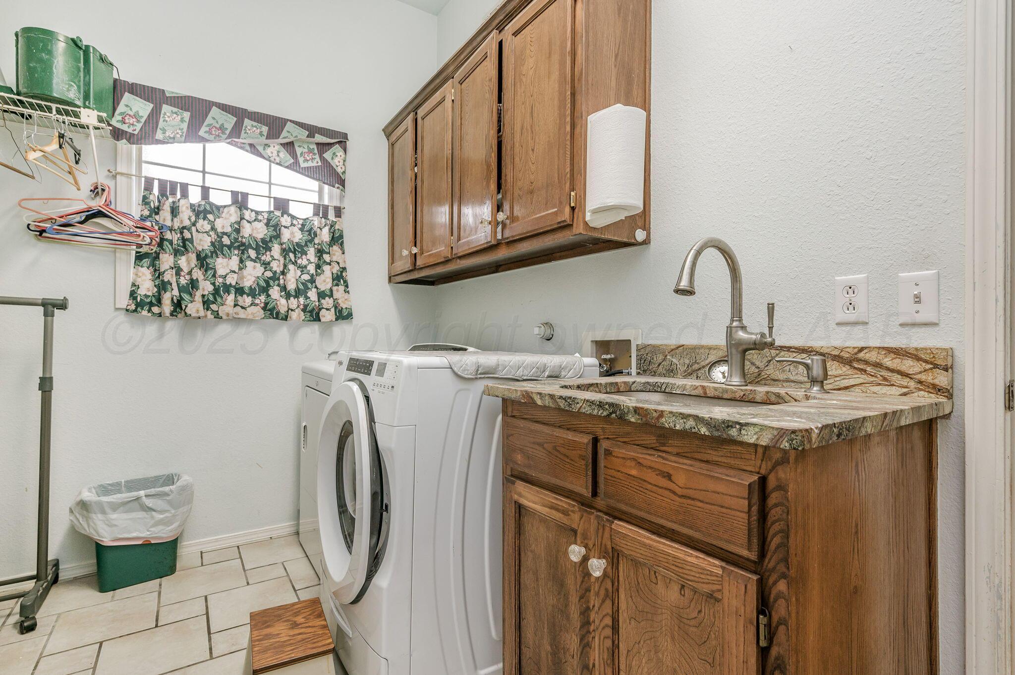 7809 Bent Tree Drive Amarillo, TX 79121 - Photo 19 of 31 a bathroom with a granite countertop sink a toilet and a shower curtain