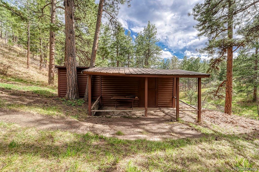 9088 South Murphy Gulch Road Littleton, CO 80127 - Photo 16 of 50 a view of house with backyard and trees