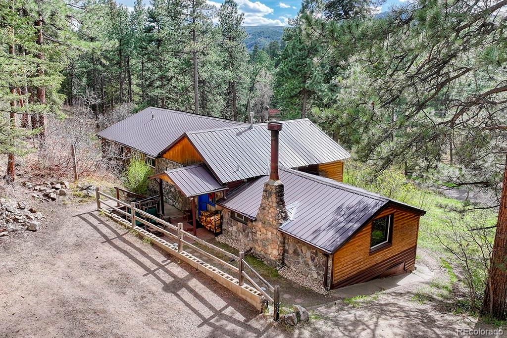 9088 South Murphy Gulch Road Littleton, CO 80127 - Photo 2 of 50 an aerial view of a house with a yard