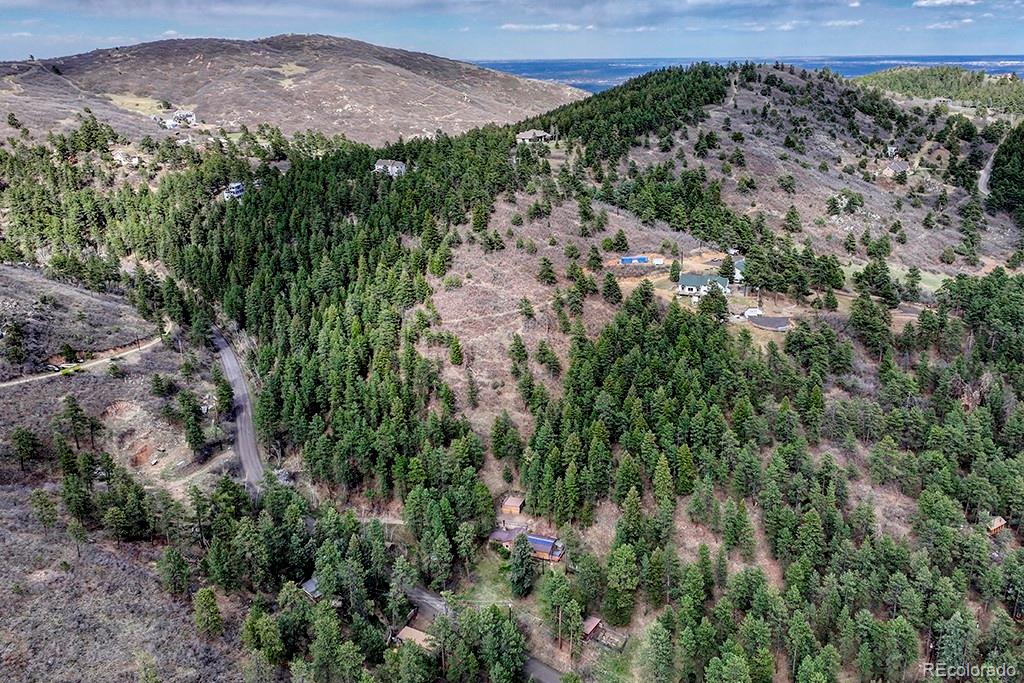 9088 South Murphy Gulch Road Littleton, CO 80127 - Photo 23 of 50 a view of a houses with a lush green hillside