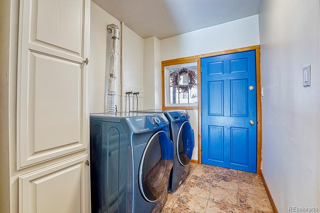 9088 South Murphy Gulch Road Littleton, CO 80127 - Photo 28 of 50 a view of front door with washer and dryer