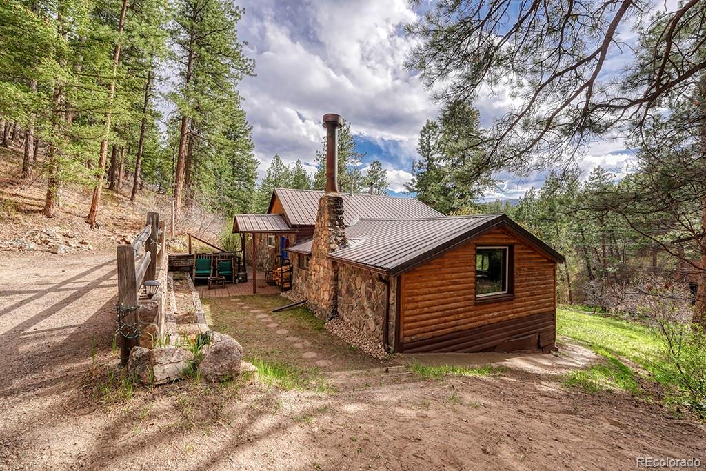 9088 South Murphy Gulch Road Littleton, CO 80127 - Photo 3 of 50 a view of a house with a wooden fence next to a yard