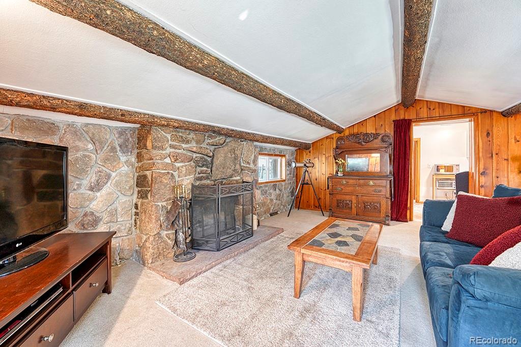 9088 South Murphy Gulch Road Littleton, CO 80127 - Photo 34 of 50 a living room with furniture a flat screen tv and floor to ceiling window