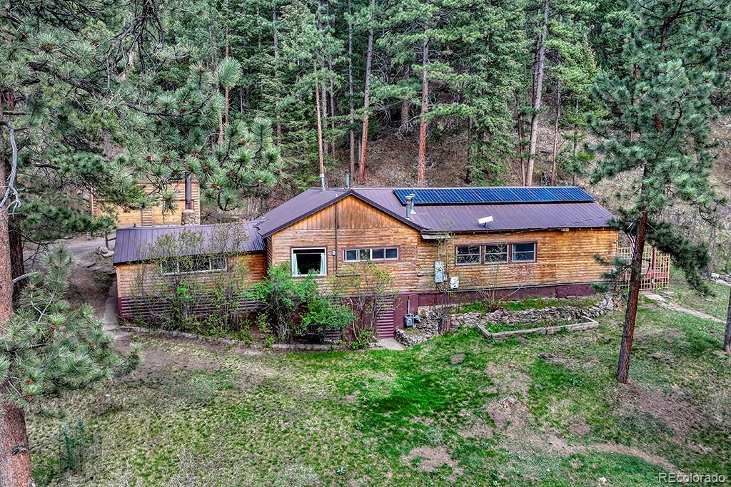 9088 South Murphy Gulch Road Littleton, CO 80127 - Photo 7 of 50 a backyard of a house with plants and large trees