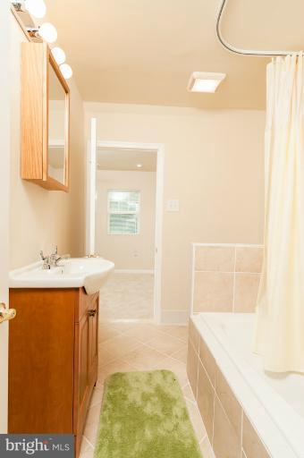 1319 3rd Road Baltimore, MD 21220 - Photo 13 of 29 a bathroom with a tub sink and mirror