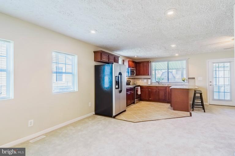 1319 3rd Road Baltimore, MD 21220 - Photo 20 of 29 a kitchen with refrigerator and window