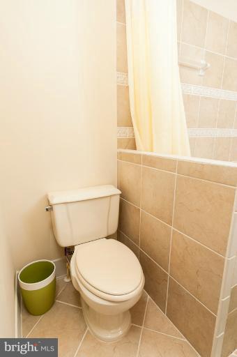 1319 3rd Road Baltimore, MD 21220 - Photo 25 of 29 a white toilet sitting next to a shower