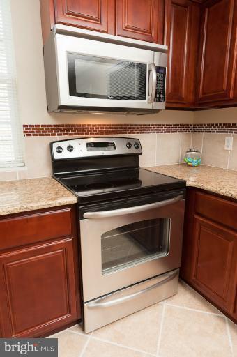 1319 3rd Road Baltimore, MD 21220 - Photo 27 of 29 a stove top oven sitting inside of a kitchen