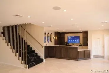 a view of a hallway with wooden floor and a living room