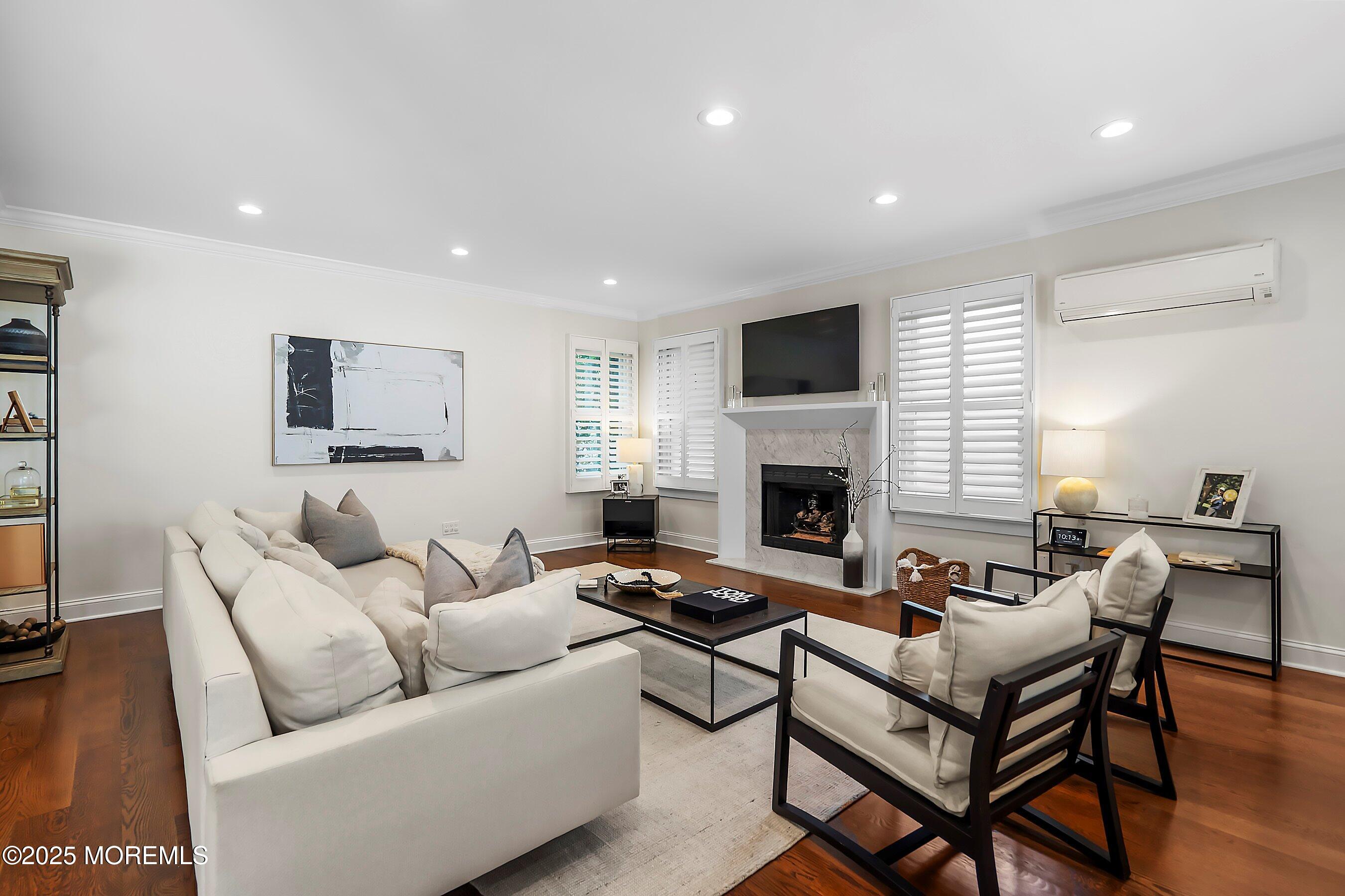 44 Ridge Road Rumson, NJ 07760 - Photo 17 of 38 a living room with furniture a flat screen tv and a fireplace