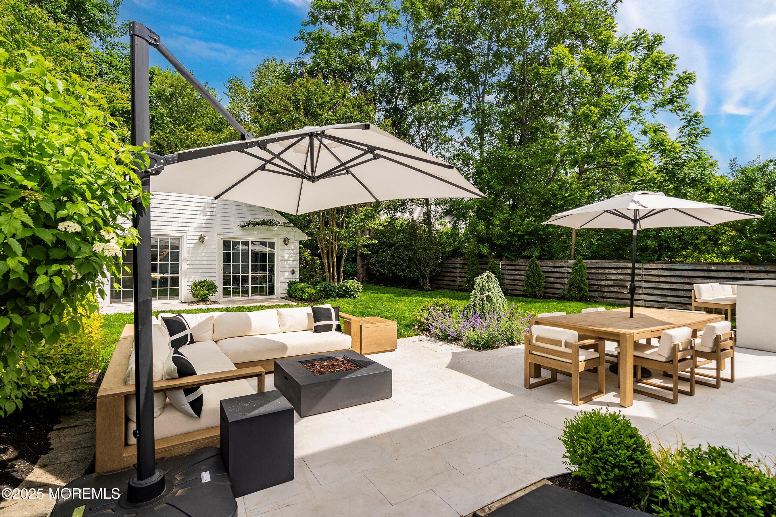 44 Ridge Road Rumson, NJ 07760 - Photo 25 of 38 a view of a patio with chairs under an umbrella