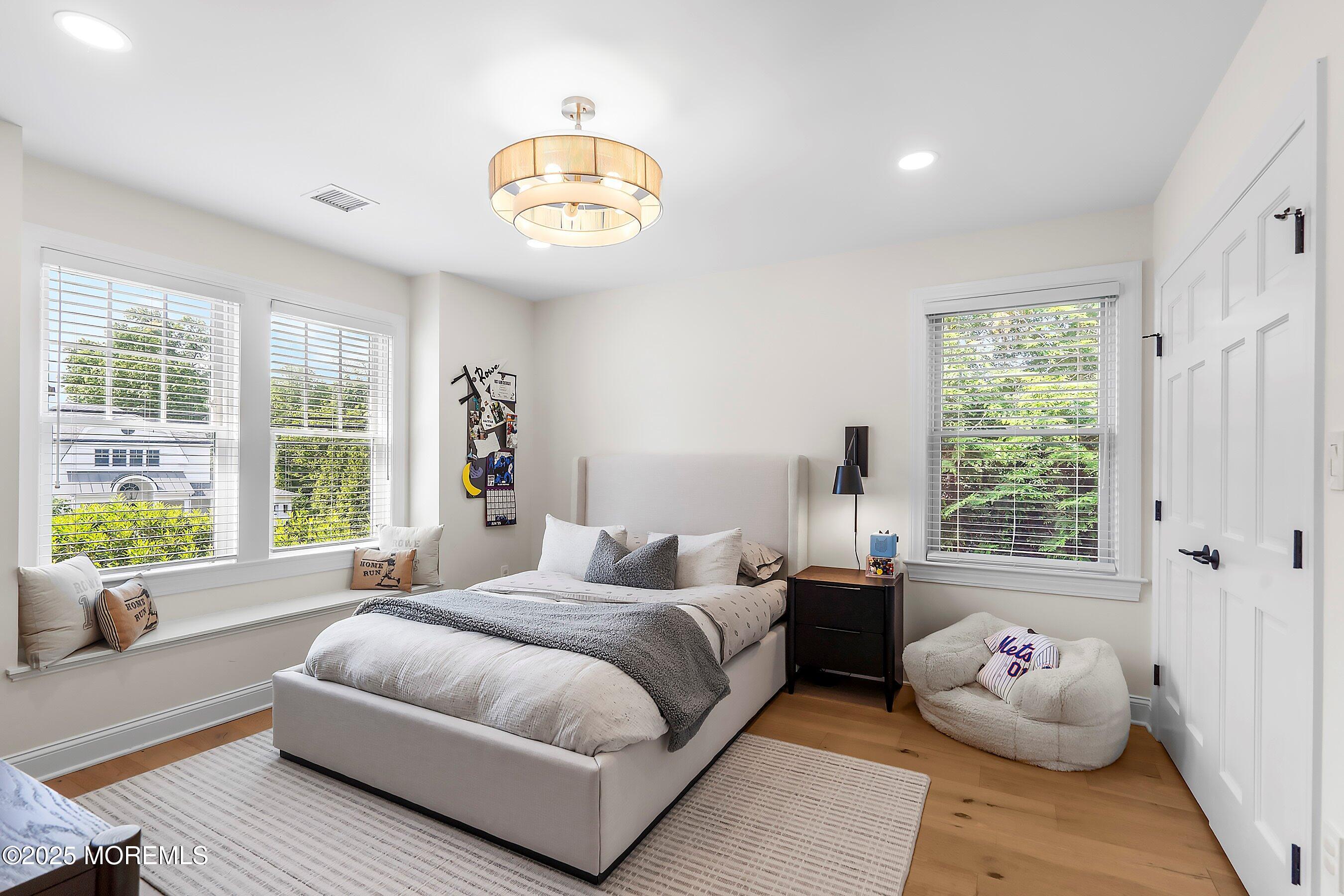 44 Ridge Road Rumson, NJ 07760 - Photo 27 of 38 a spacious bedroom with a bed and a large window
