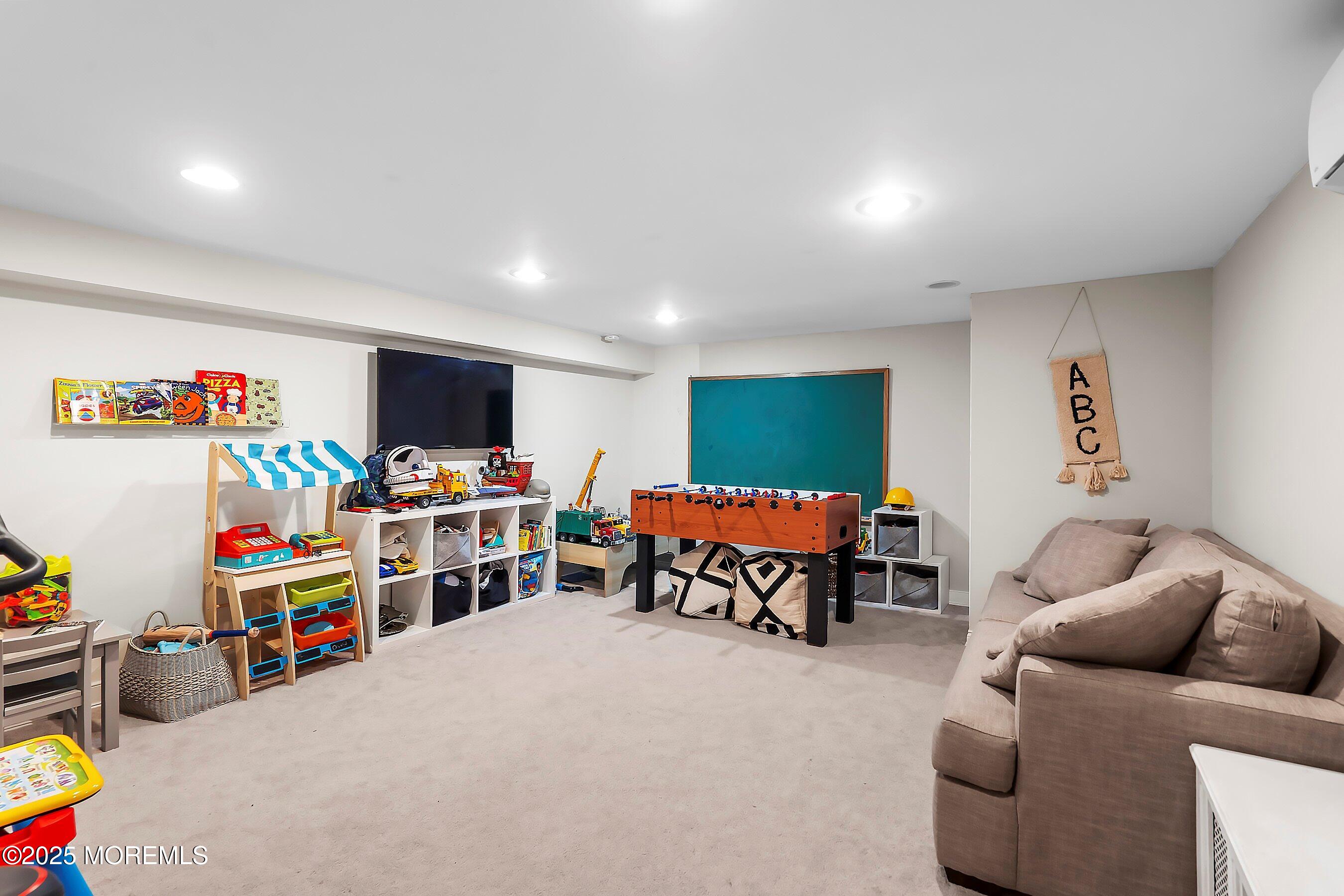 44 Ridge Road Rumson, NJ 07760 - Photo 31 of 38 a living room with furniture and a flat screen tv