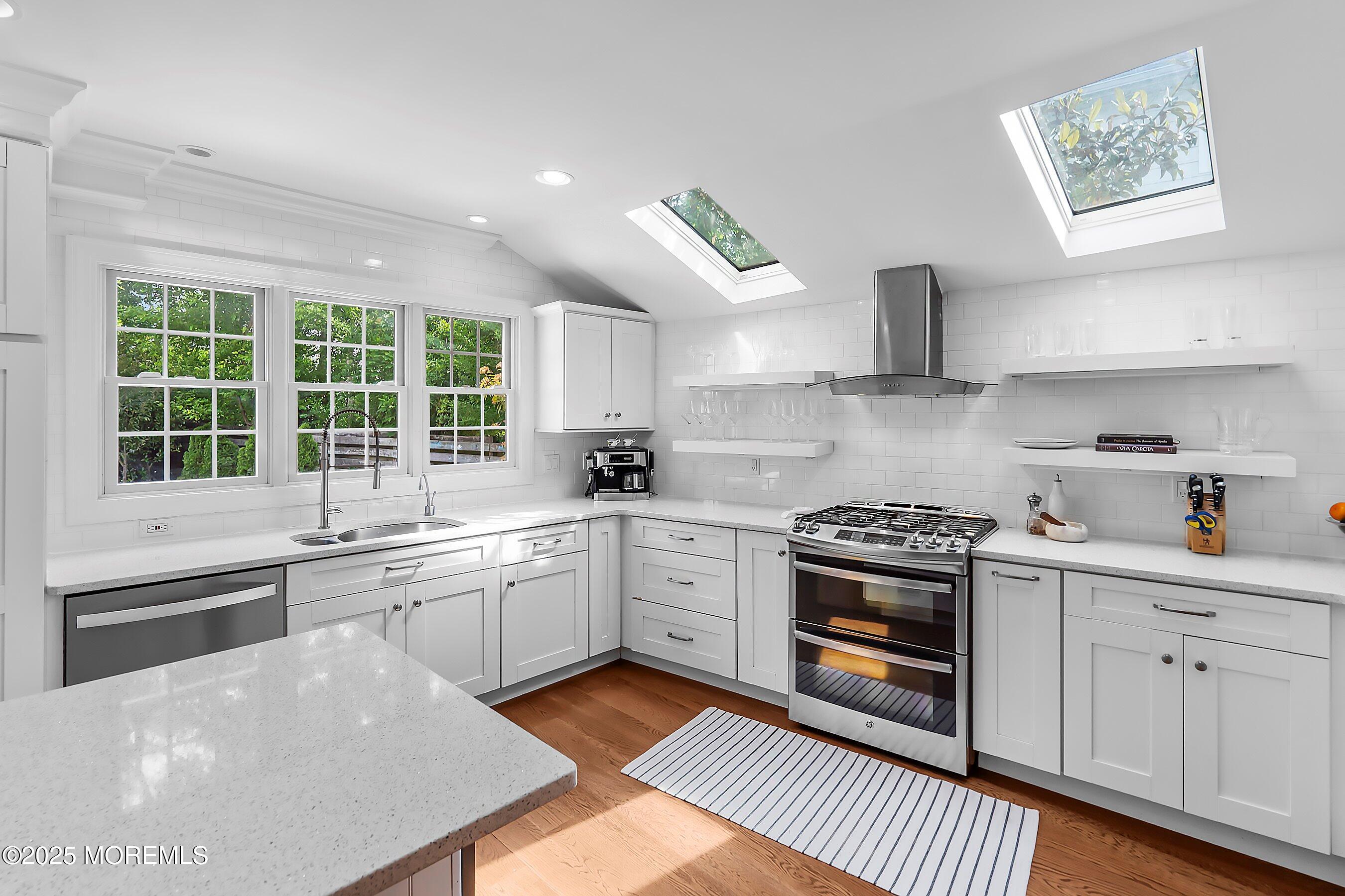 44 Ridge Road Rumson, NJ 07760 - Photo 7 of 38 a kitchen with granite countertop a sink stainless steel appliances and cabinets