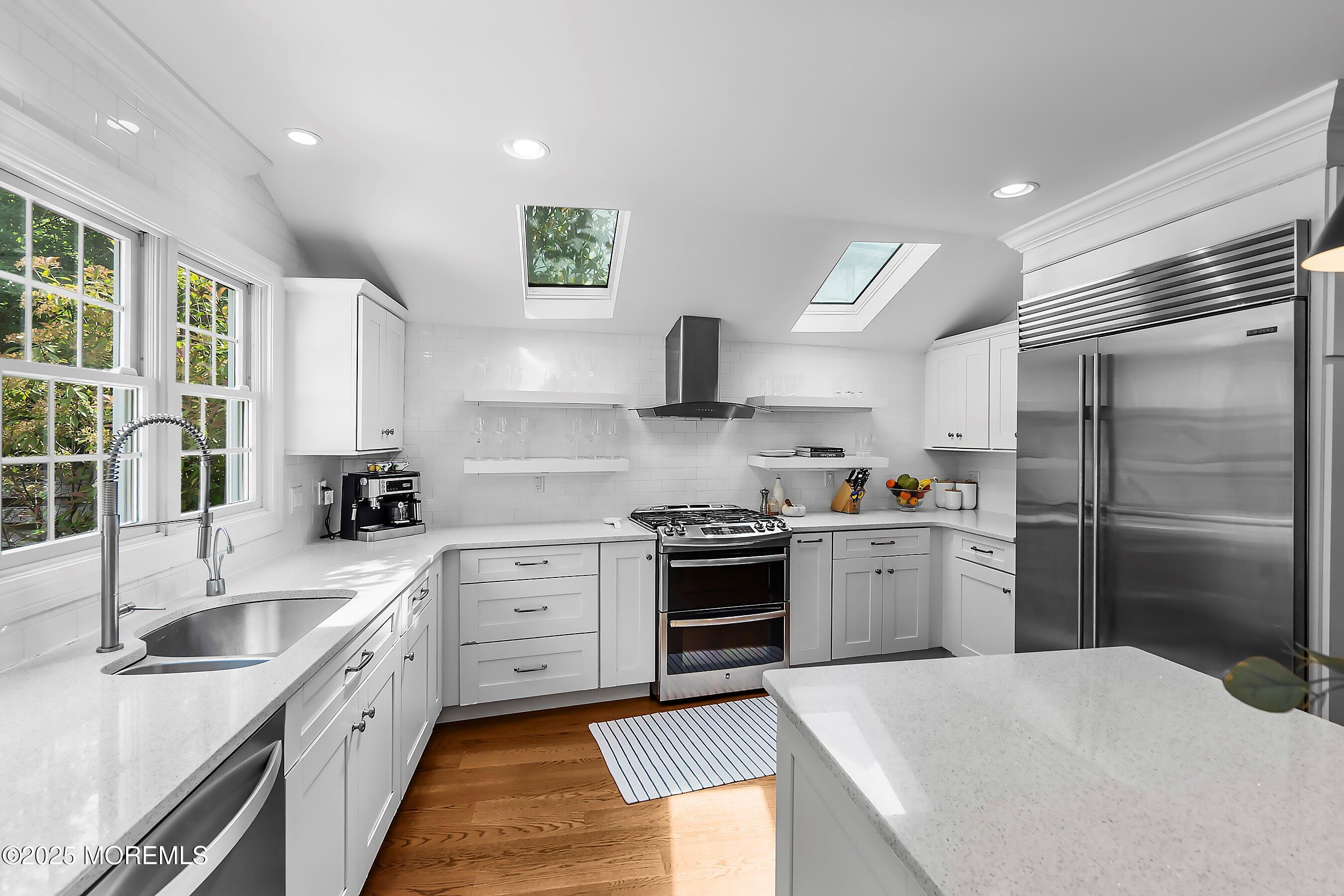 44 Ridge Road Rumson, NJ 07760 - Photo 8 of 38 a kitchen with stainless steel appliances granite countertop a sink stove and refrigerator