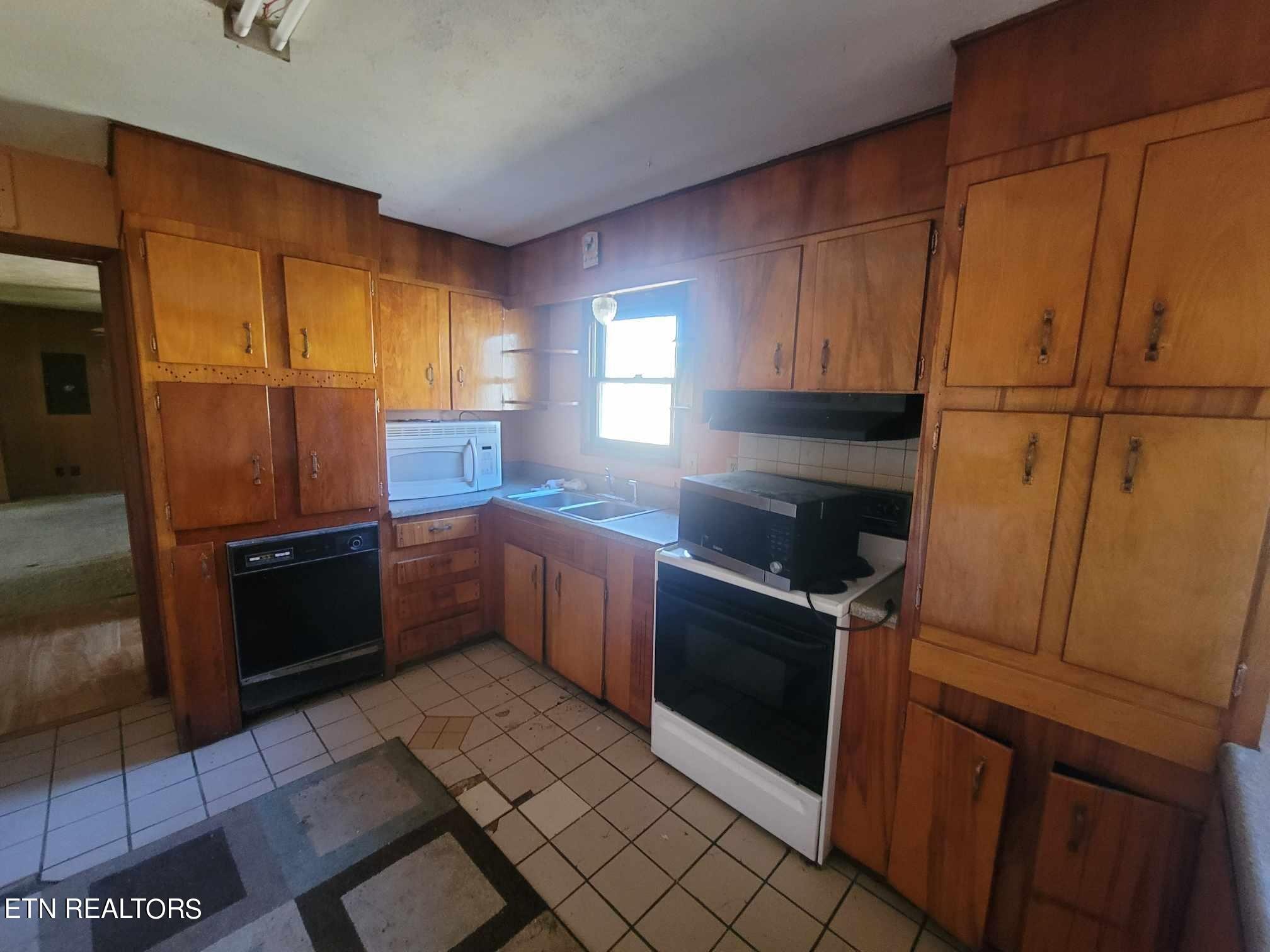 1751 Eldridge Loop Crossville, TN 38571 - Photo 9 of 35 a kitchen with granite countertop a refrigerator and a stove top oven