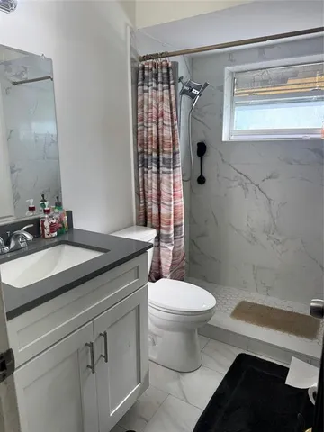 a living room with furniture a flat screen tv and a window